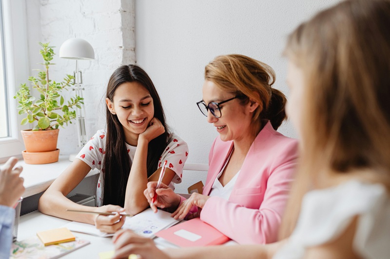 people sitting down at table working together
