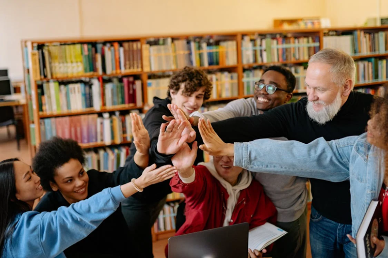 people holding hands in the air