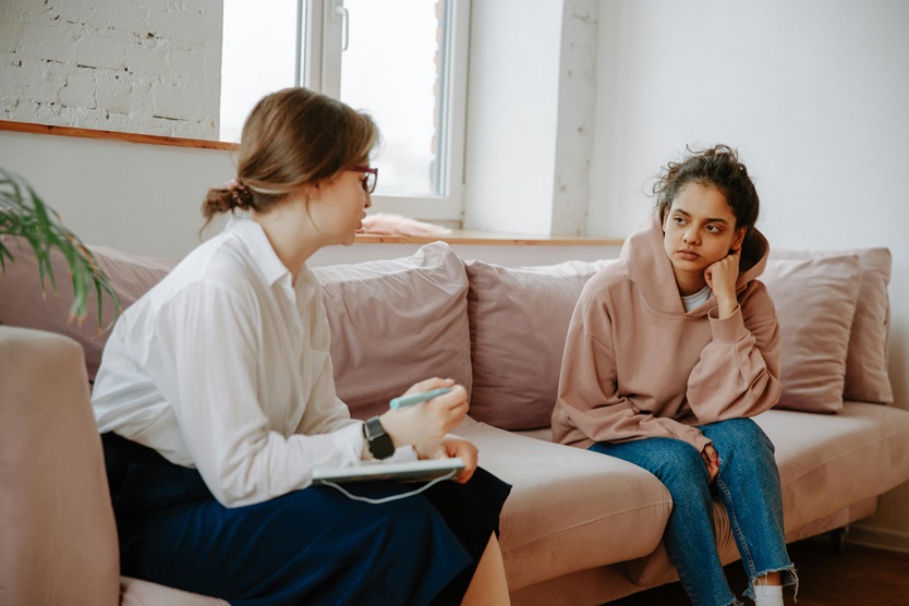girl in a residential treatment facility talking to a therapist about trauma